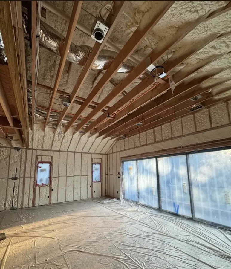 Interior walls and ceiling insulated with spray foam during new construction in East Longmeadow